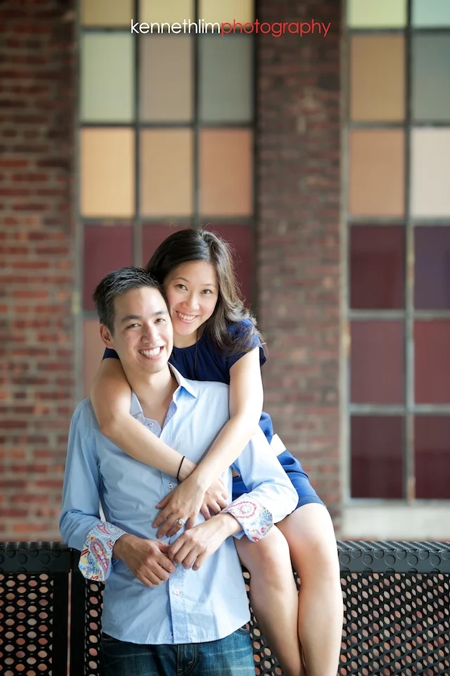 New York engagement photoshoot couple sitting on railing