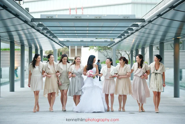 Hong Kong wedding Four Seasons reception portrait session bride with bridesmaids laughing walking hand in hand