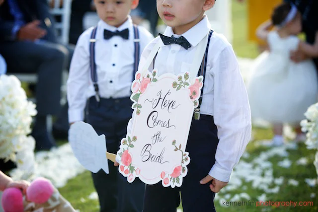 Koh Samui wedding YL Residence ring boy walking with sign