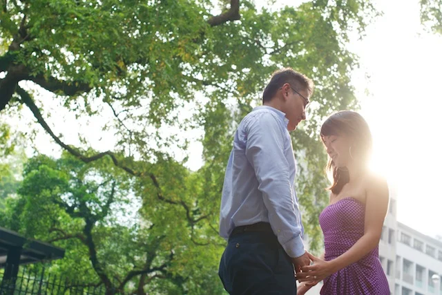 Hong-Kong-Park-engagement-photoshoot-couple-holding-hands-sun-in-back