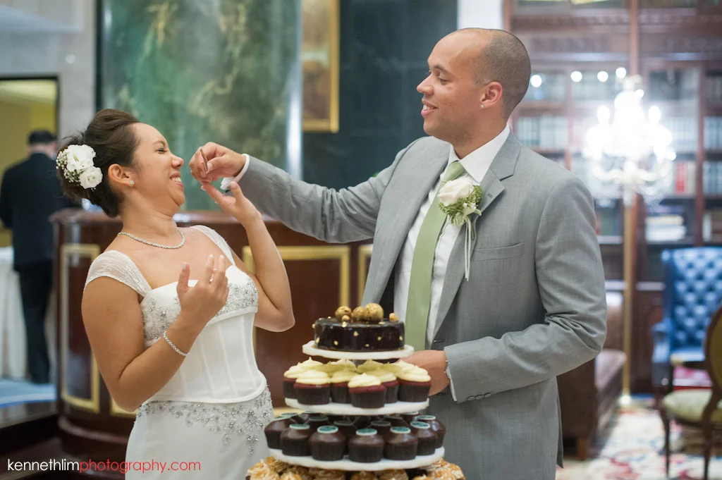 Hong Kong Island Shangri-la Atrium Library wedding day photography groom feeding bride cake after cake cutting ceremony