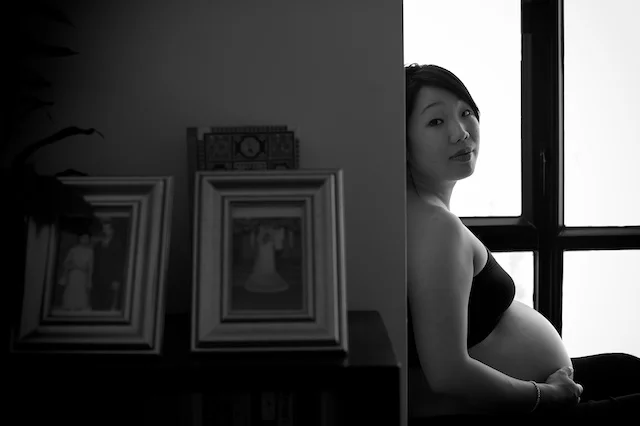 pregnant mother at home with her family photos
