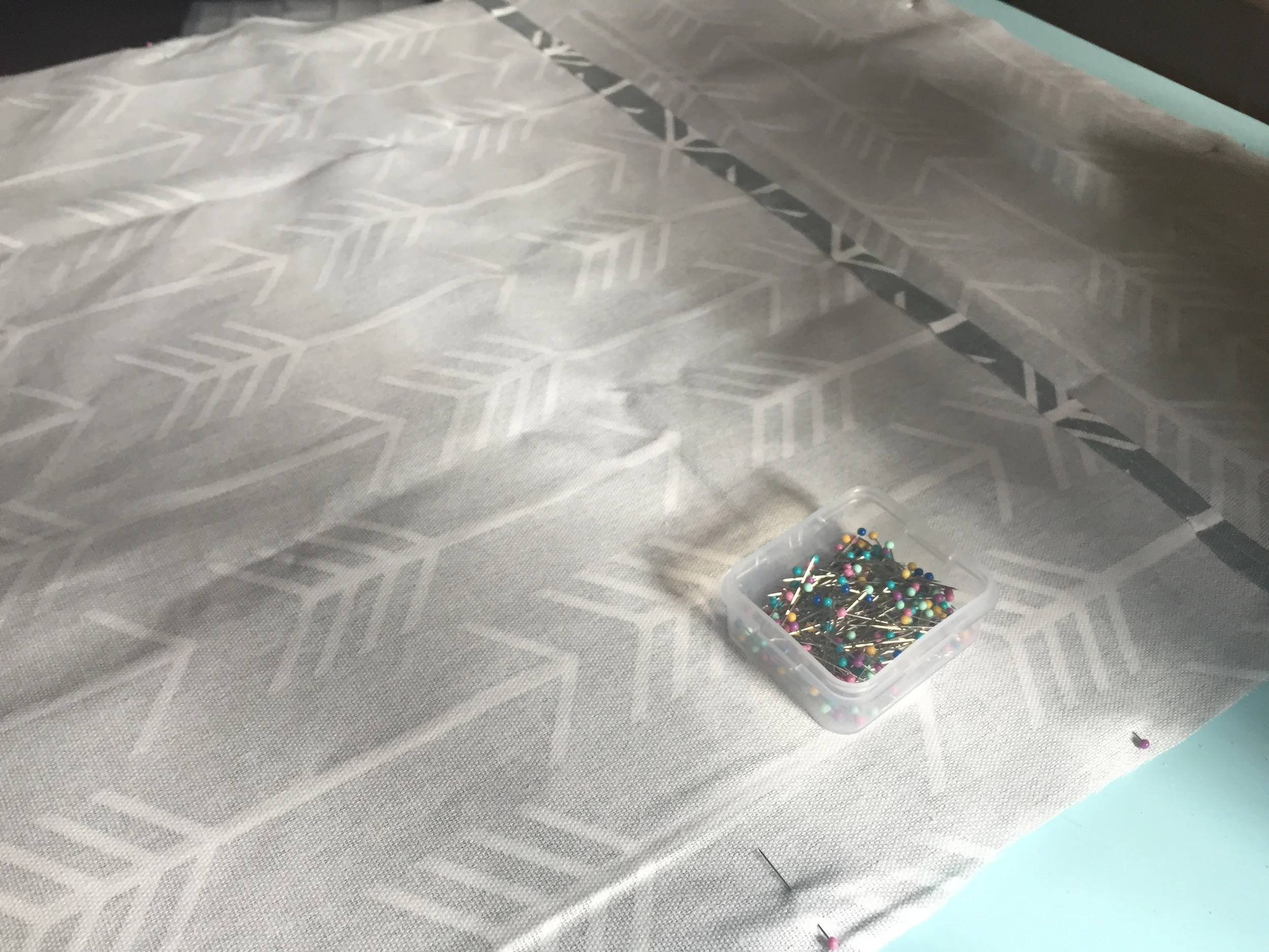 Your envelope pieces will overlap each other a bit and that is ok! Then take straight pins and pin around the edges of entire piece to ensure it stays in place while sewing.