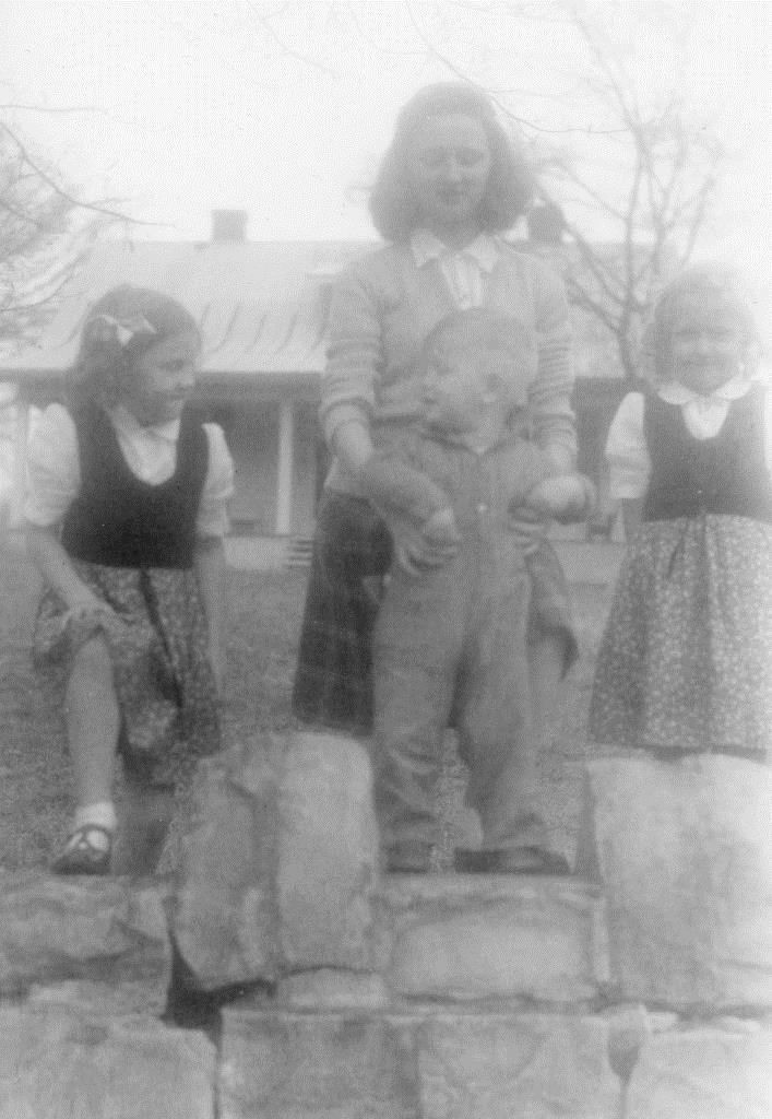 Lucy, George and Georgianna in front of Whooping Crane Farm, 1942