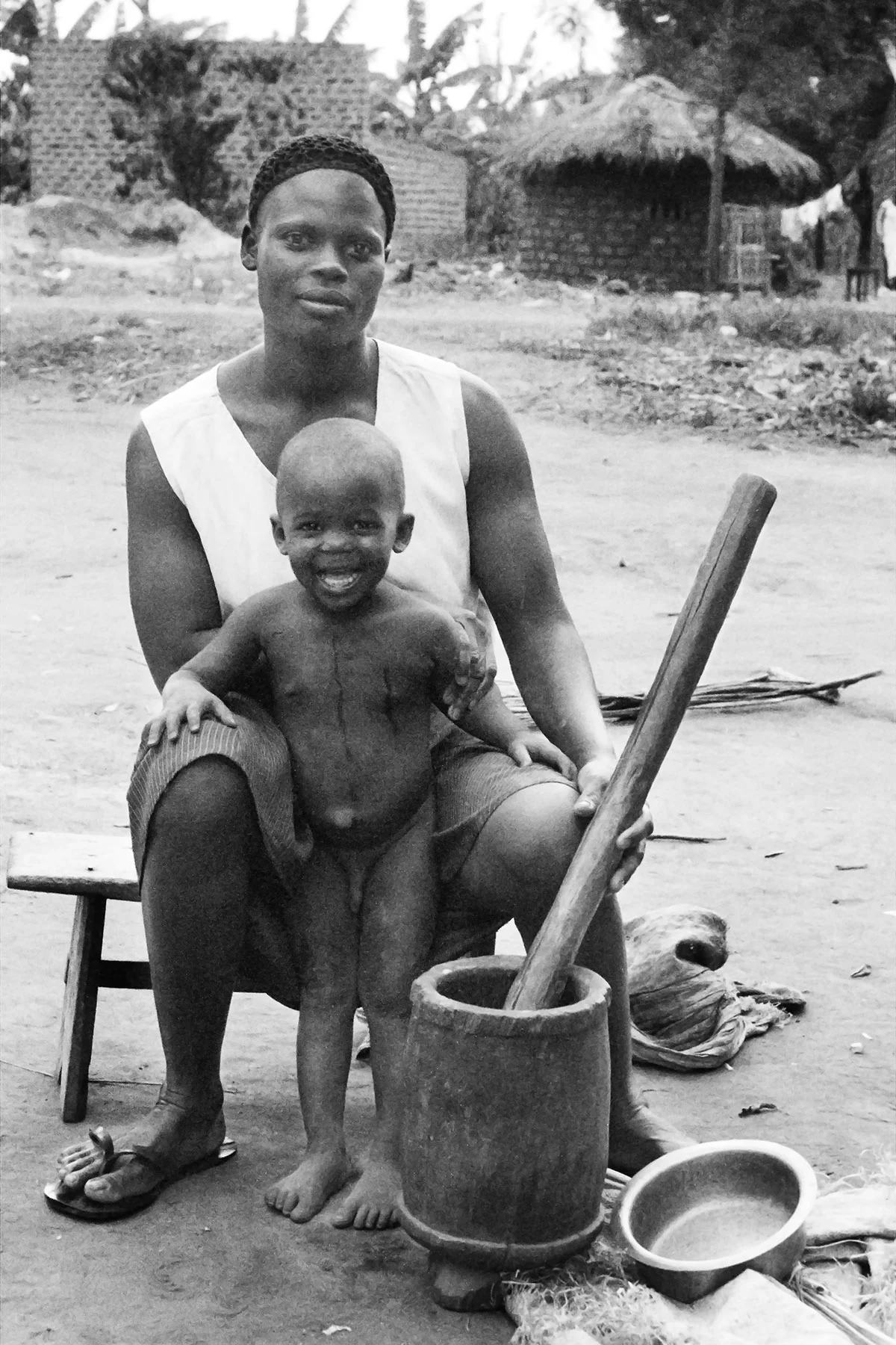 Photographer: Anyango Florence. Age: 29 years. Occupation: Teacher at BESO Junior School. "This lady was using a lot of energy to grind her ground nuts. This is our common grinding mechanism for the source. It is one of the staples of our diet in the Buganda kingdom, and this photo shows the very traditional way of life that we lead here in the village."