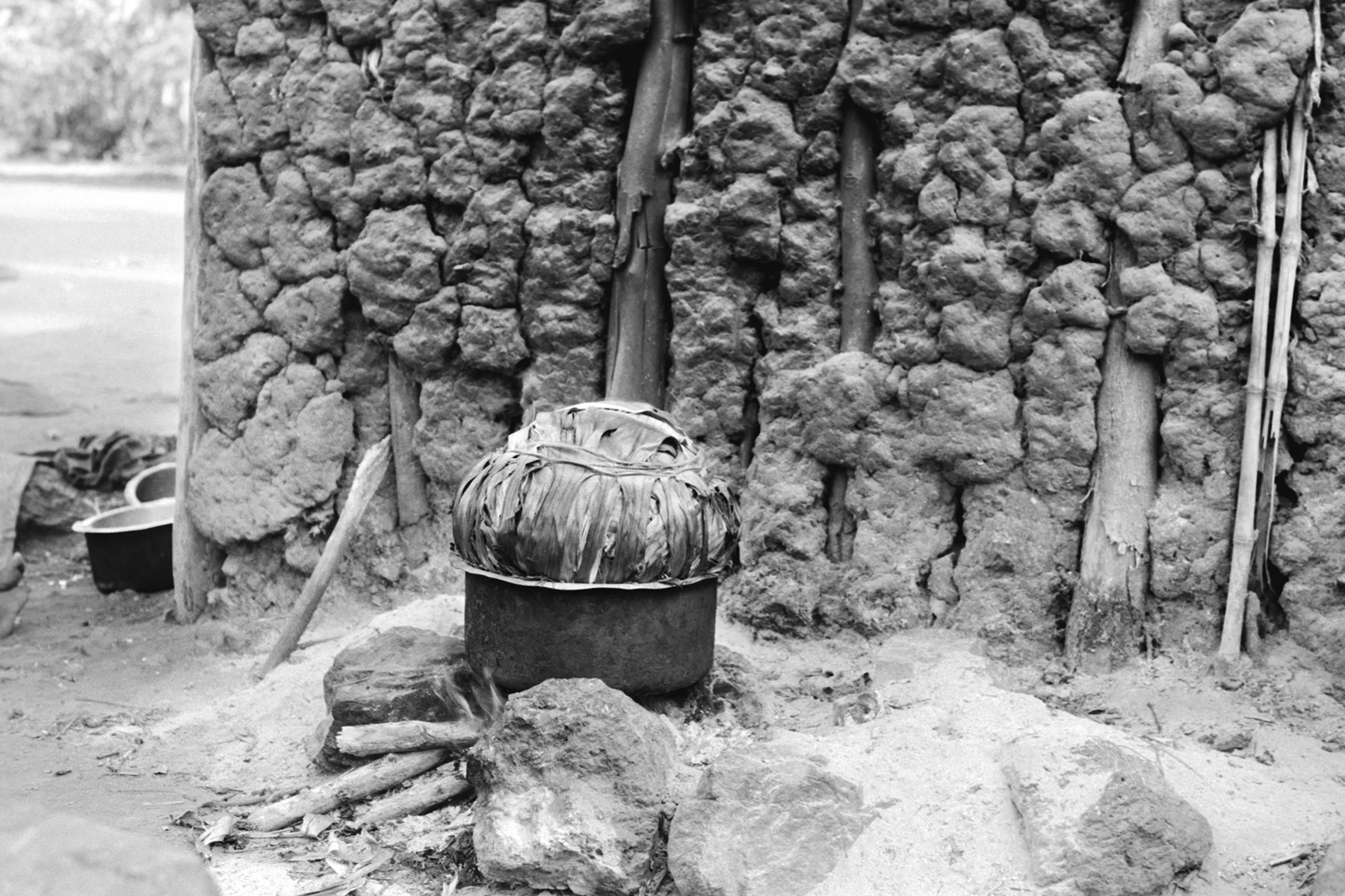 Photographer: Achieng Margaret. Age: 24 years. Occupation: Farmer. "This is my beautiful saucepan that I use for preparing meals for my children. Here I am preparing matoke wrapped in banana leaves, the traditional food of the Buganda Kingdom." 