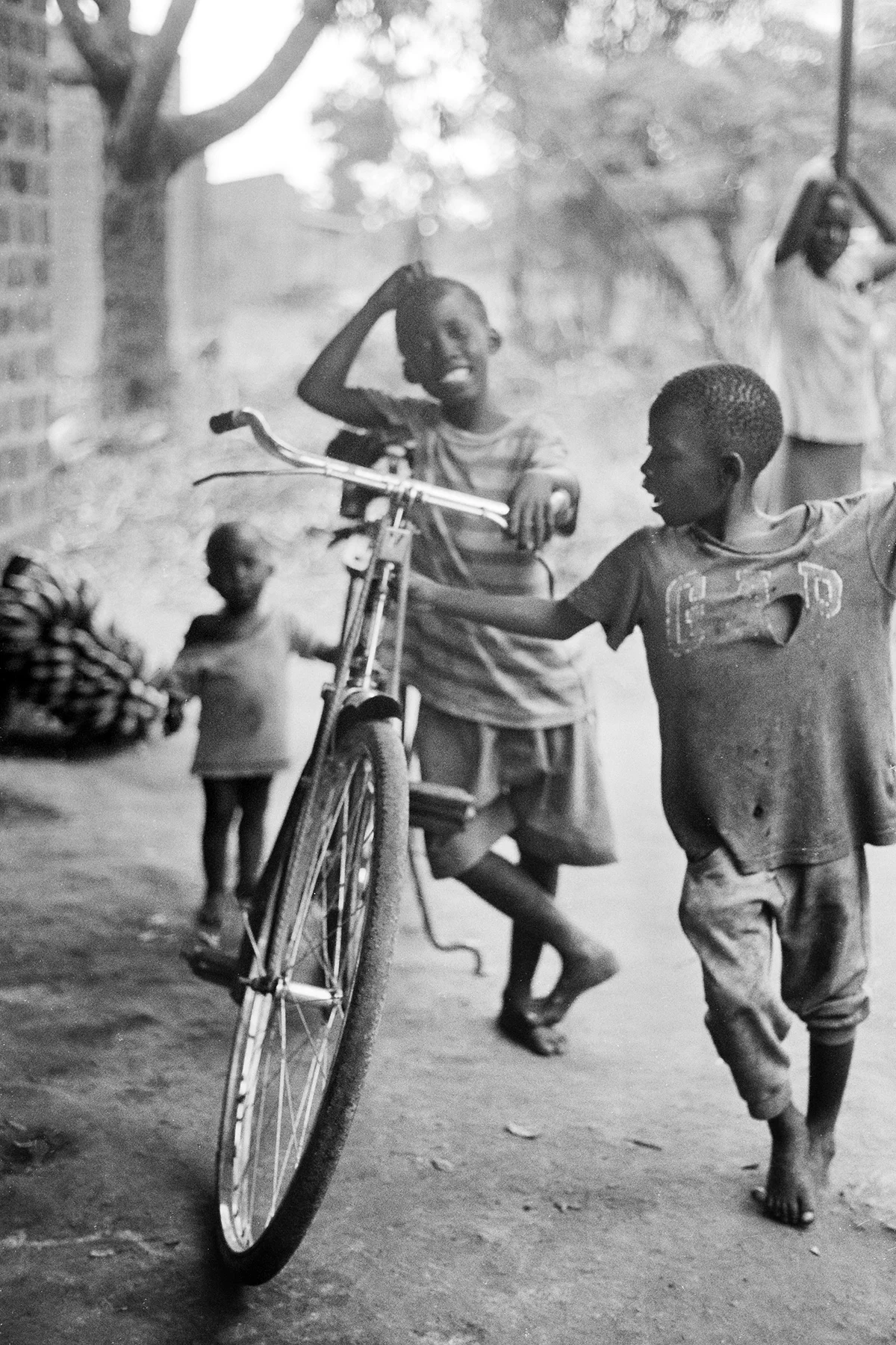 Photographer: Mpiima Zacharious. Age:13 years. Occupation: Student at BESO Junior School. "These are my very best friends. The bicycle allows us to have so much fun on our way to and fro school."