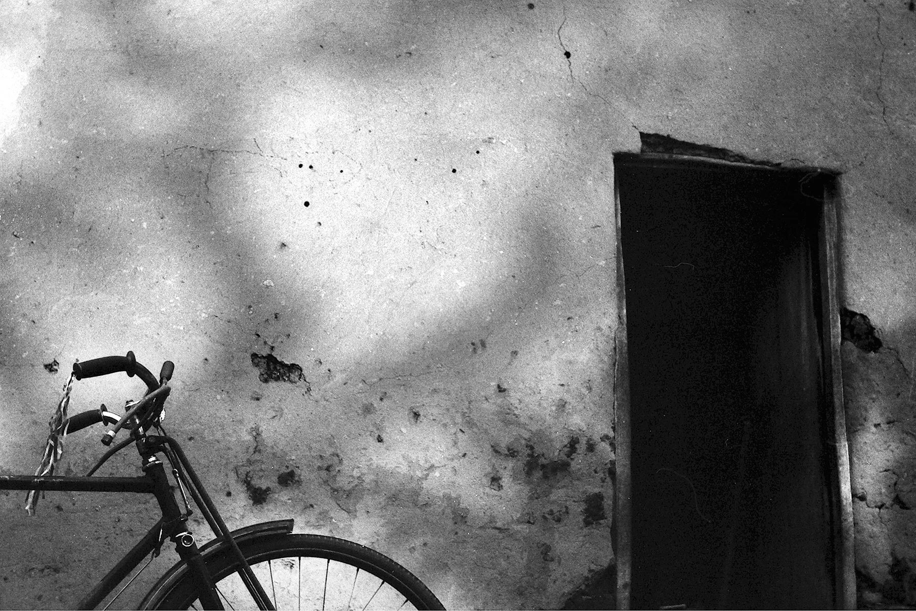 Photographer: Nabunya Rose. Age: 52 years. Occupation: Farmer. "This is my neighbor's son's house, and his bicycle. He studies with my son Bulega Julius. "