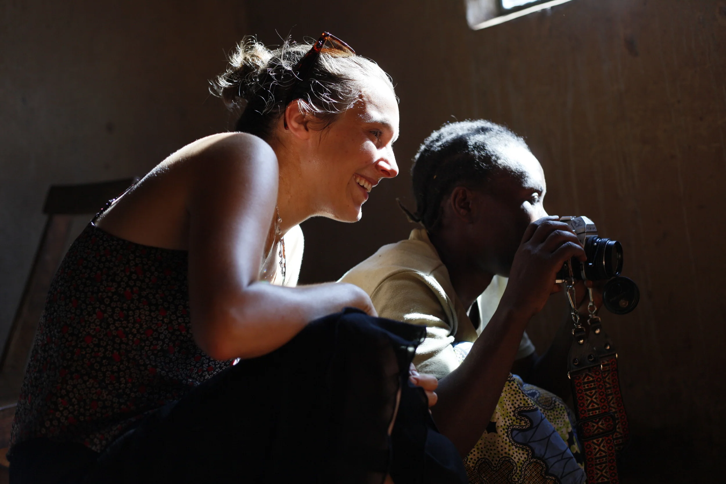 Project Director and field facilitator Louise Contino working one-on-one during a home visit with WPC member Babigumira Florence. 