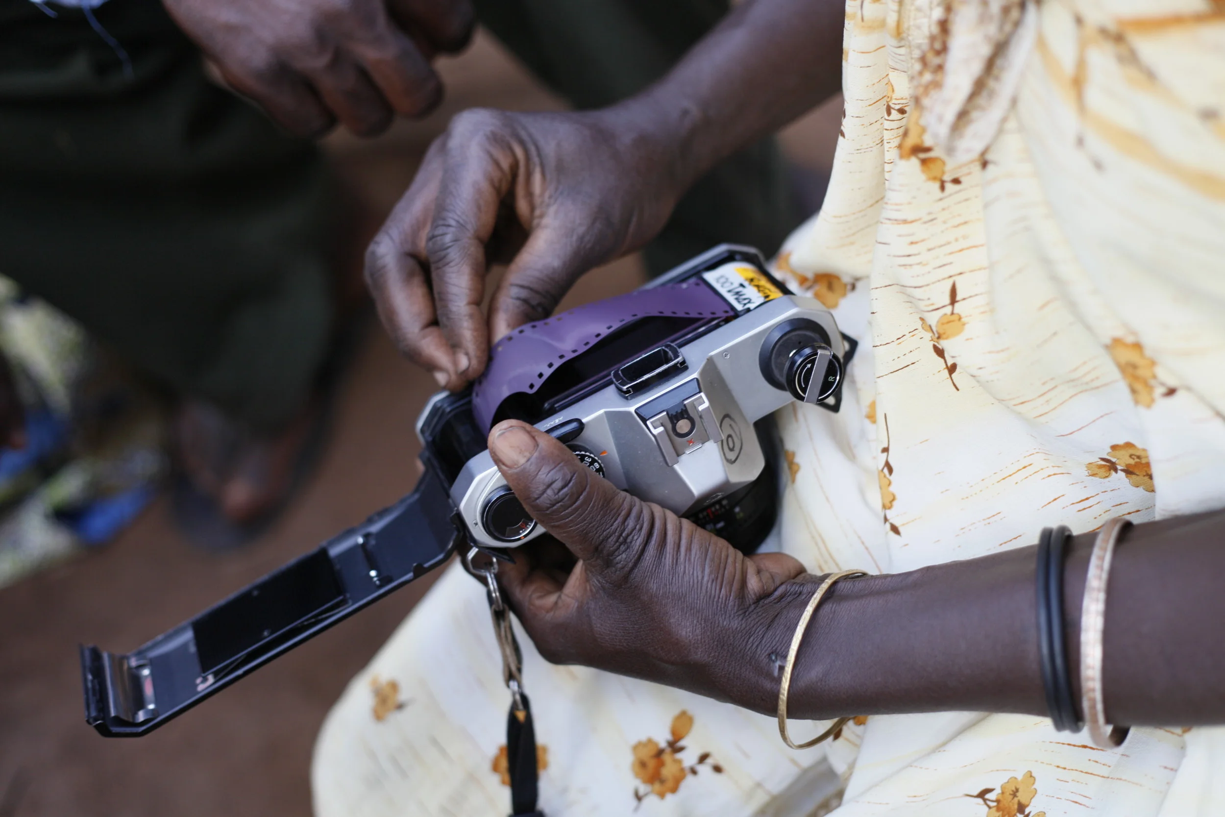  Nalongo Bukenya manually loading a roll of back and white film.&nbsp; 