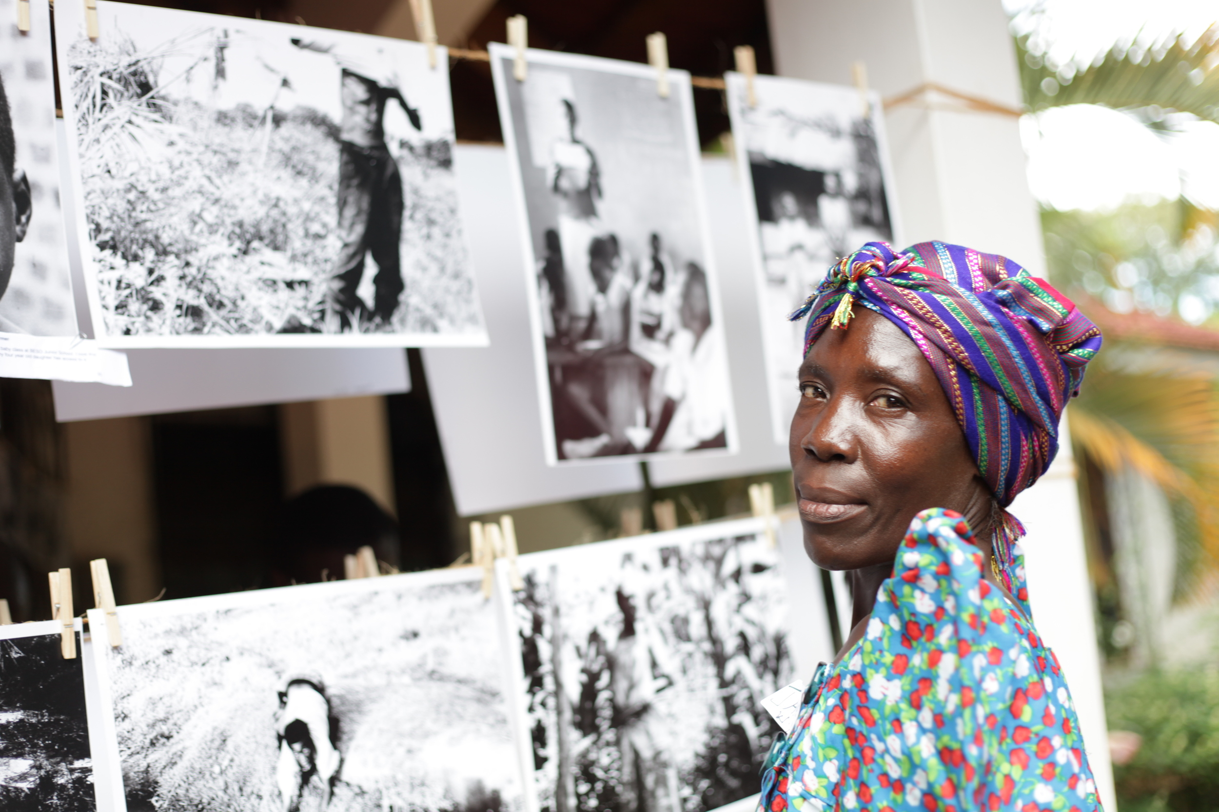  WPC member Athieno Jane in front of the WPC's photographic works presented at the  Picturing Wanteete  Kampala Exhibition in May of 2014. 
