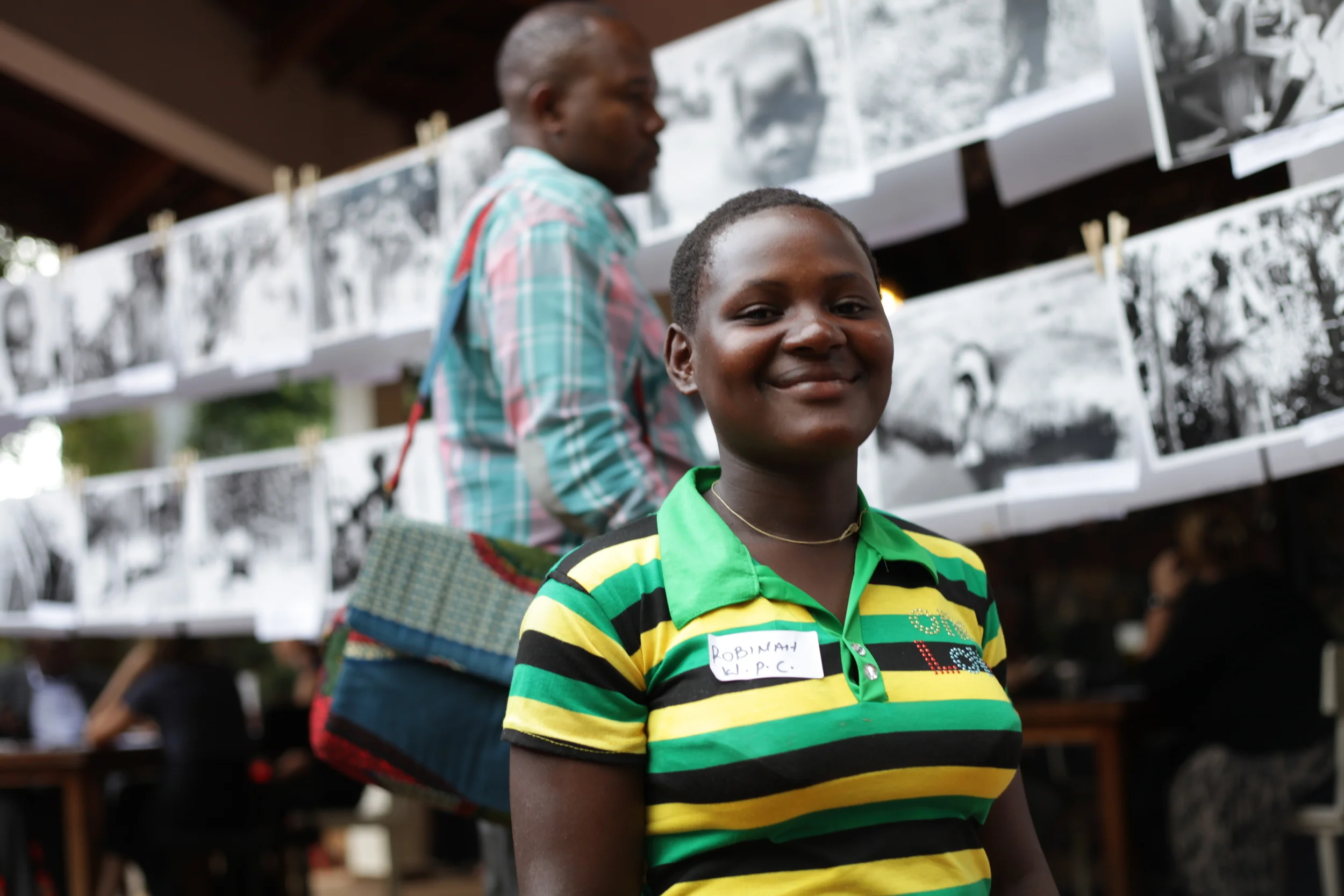  WPC member Robinah Kafuko&nbsp;in front of the WPC's photographic works presented at the&nbsp; Picturing Wanteete &nbsp;Kampala Exhibition in May of 2014. 