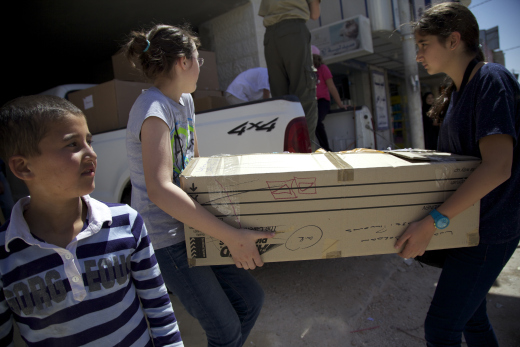 Children unloading the trucks in Mafraq.