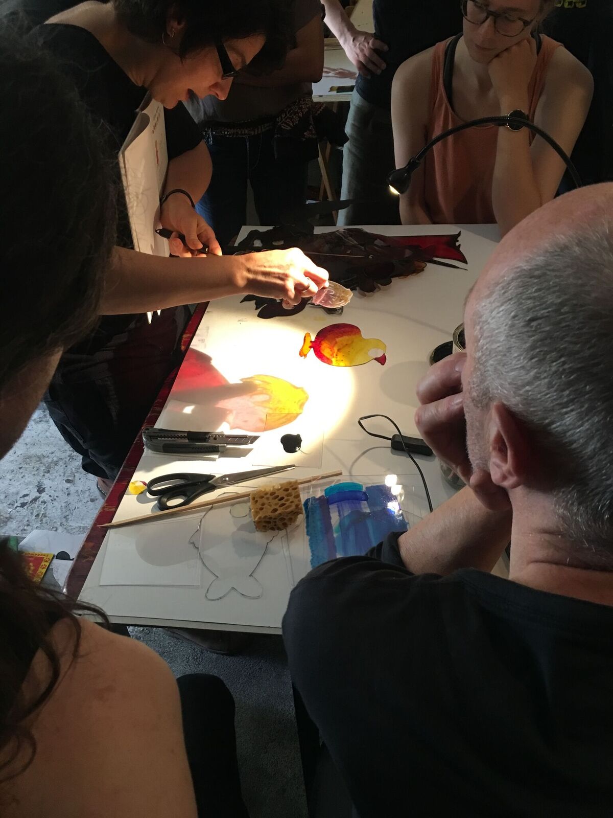 Teatro Gioco Vita designer Nicoletta Garioni leading a lecture on colored shadow puppets. Here, she demonstrates the use of glass paint on polycarbonate. Photos provided by Dustin Curtis. 