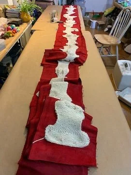 Knitted long meandering road backed with red cloth. Photo: Deborah Hunt