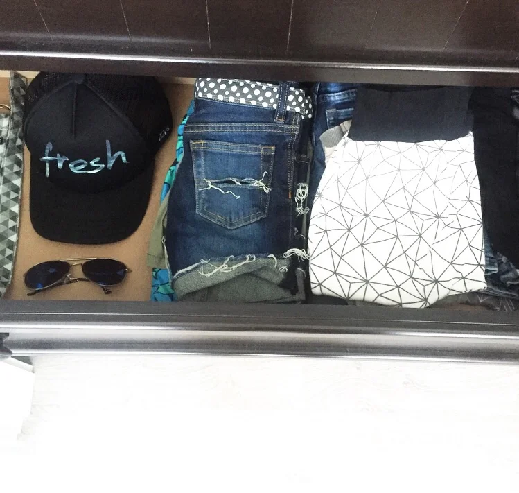 Accessories, shorts, and pants in the second drawer.