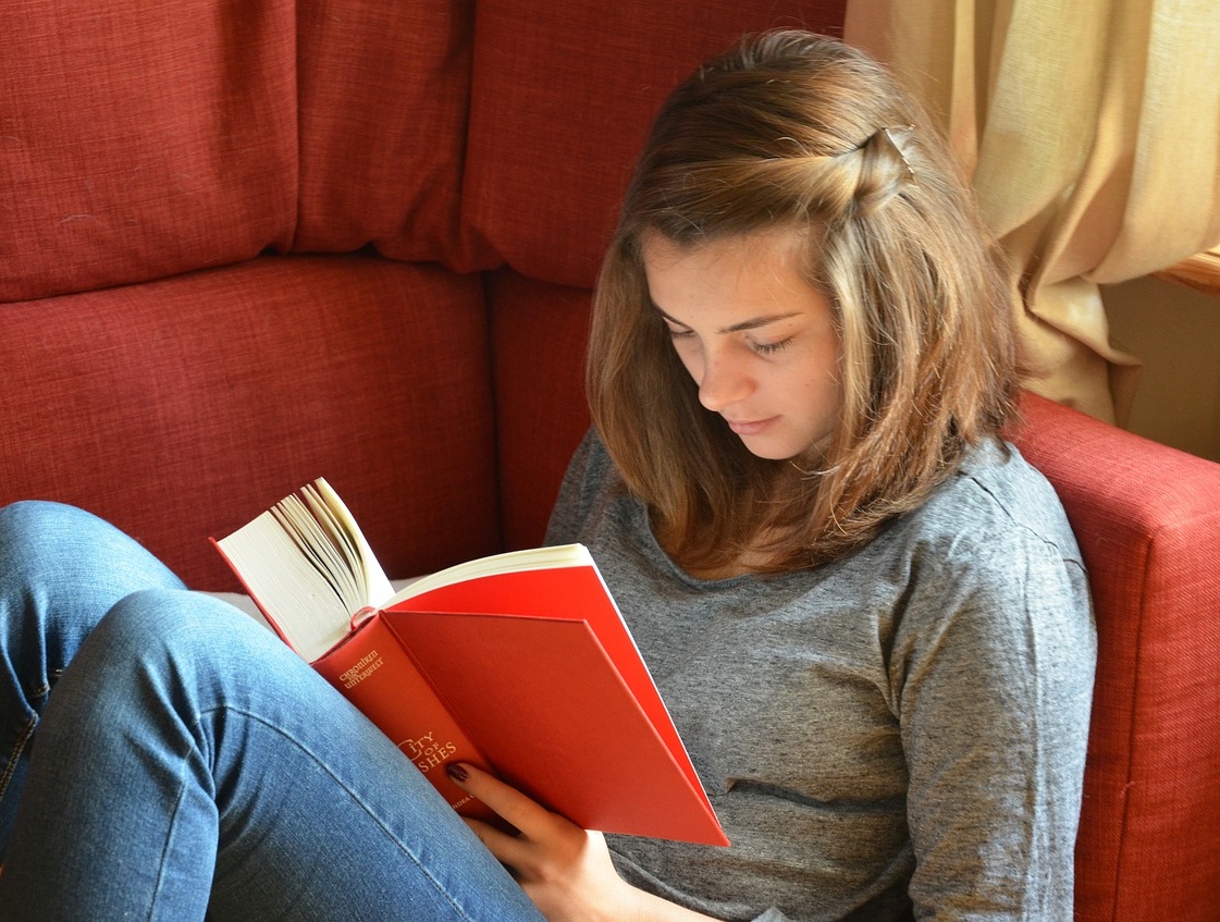 student+reading+a+book+in+comfortable+chair.jpg
