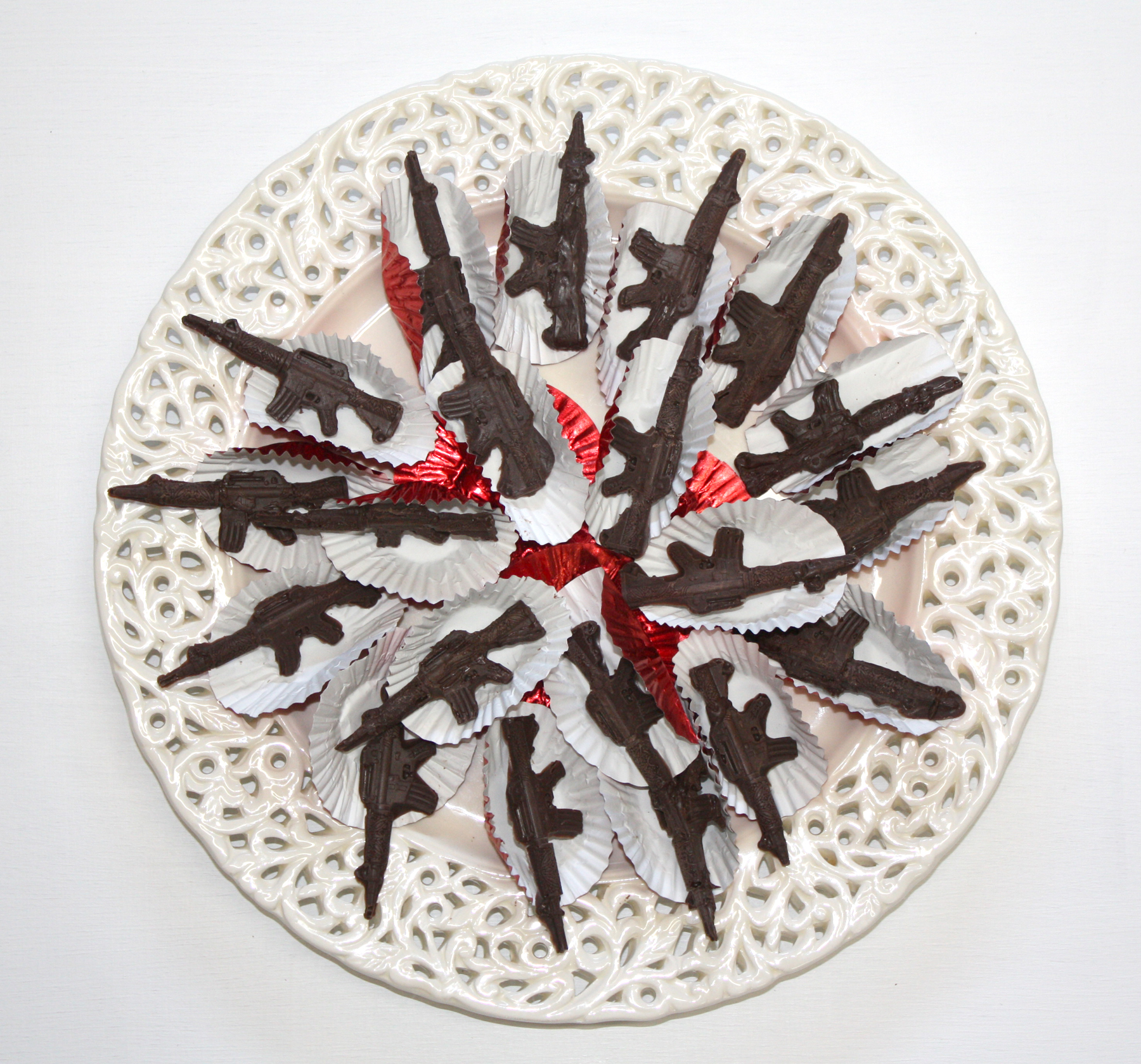 moya_devine_TANSTAAFL_detail_chocolate guns on plate.jpg