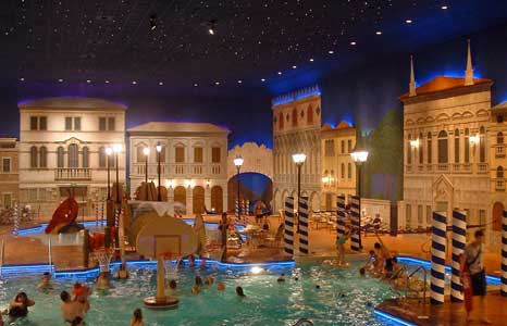 A busy Indoor pool with a nighttime city street theme at the Holiday Inn in Maple Grove , MN