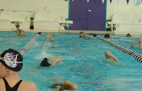 People swimming in the pool at Waunakee High School in Waunakee, WI