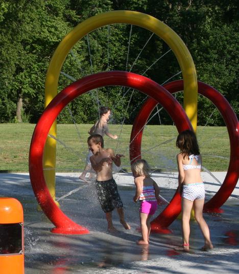 Kids playing at the outdoor splash pad area at El Dorado Sprayground in KS