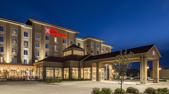 Night time view of the front of Hilton Garden Inn in Bettendorf, IA