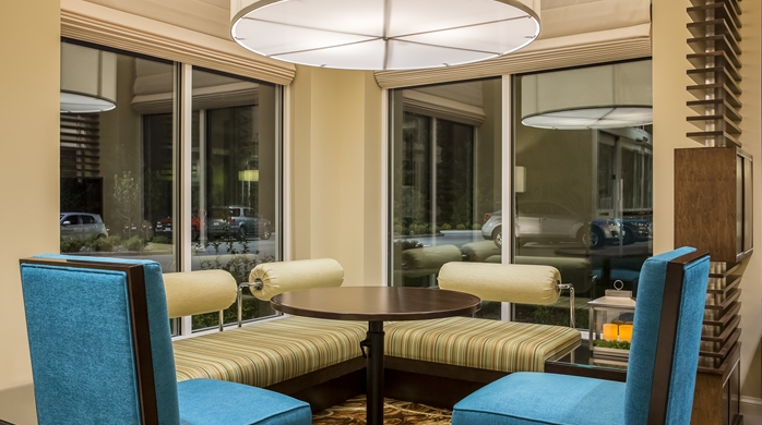 Corner seating area with booth, chairs and table at the Hilton Garden Inn in Bettendorf, IA