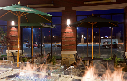 Inside seating area by a fireplace at Green Mill in Willmar, MN