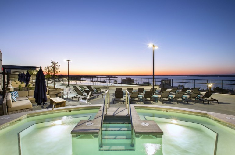 Nighttime view of the outdoor rooftop pool area at The HUB in Madison, WI