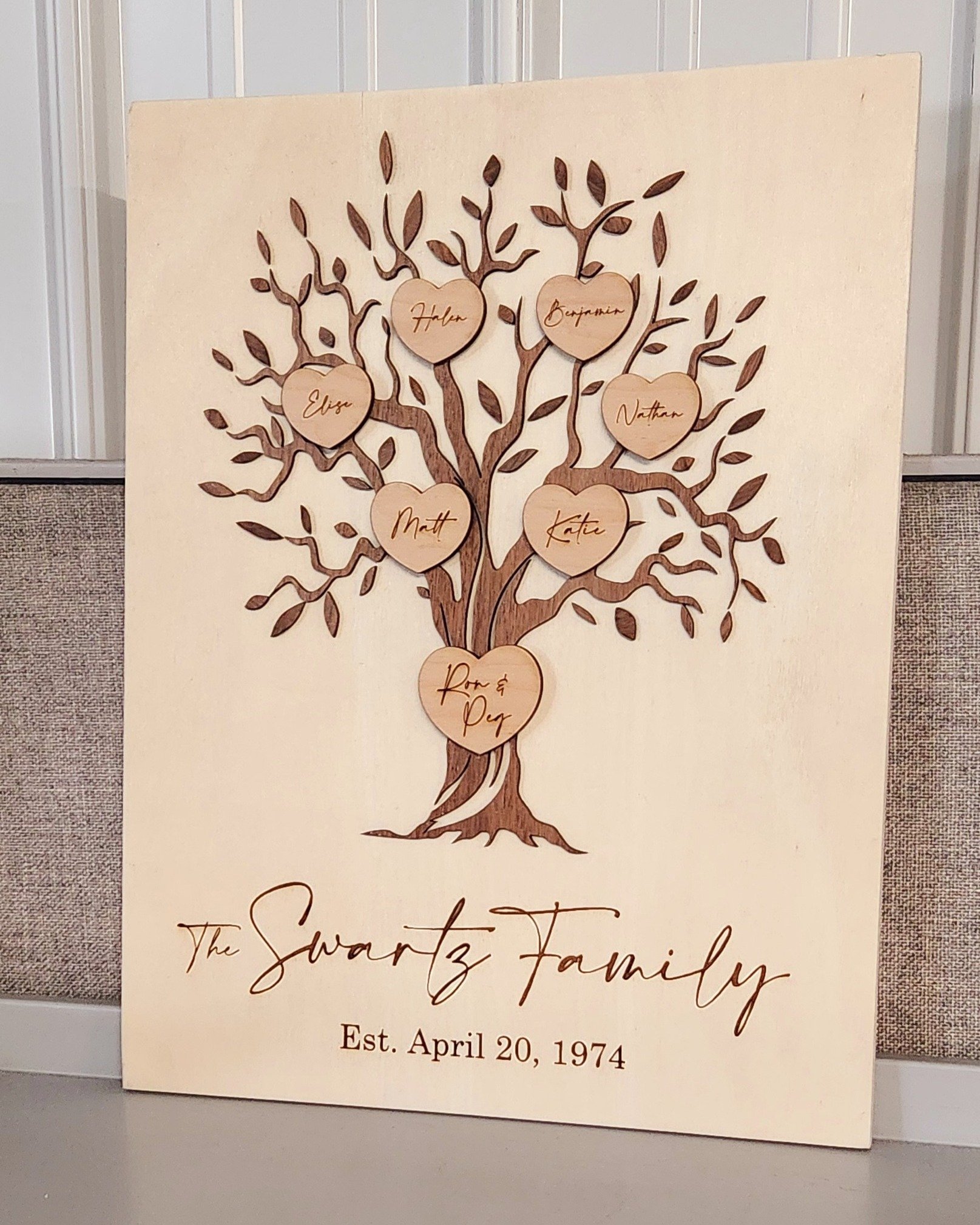 Custom laser engraved family tree on a 16x20 wood frame. The tree was laser cut out of walnut and hearts are made out of maple. Name and date lasered directly into the wood. Contact us today to get your family tree made. #zalaznikcreative #familytree