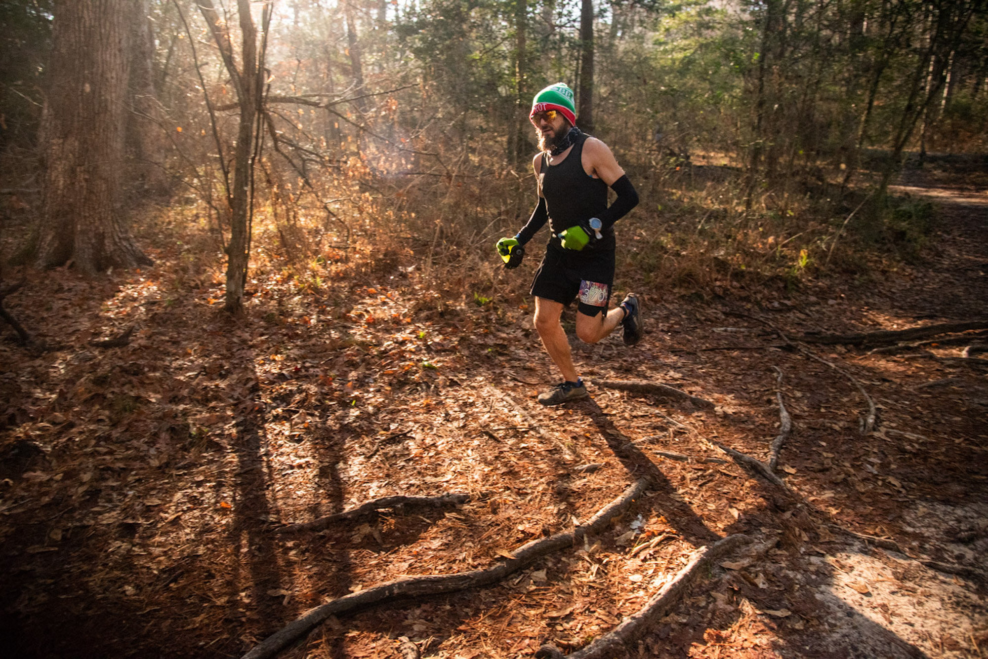 Runner on the forest trail at Rocky Raccoon 100