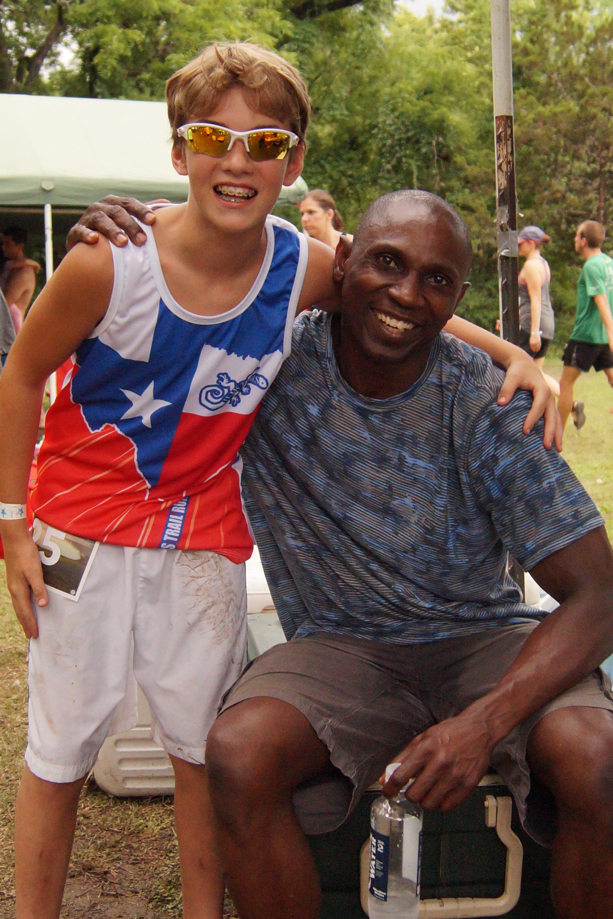  father and son posing after a trail race 