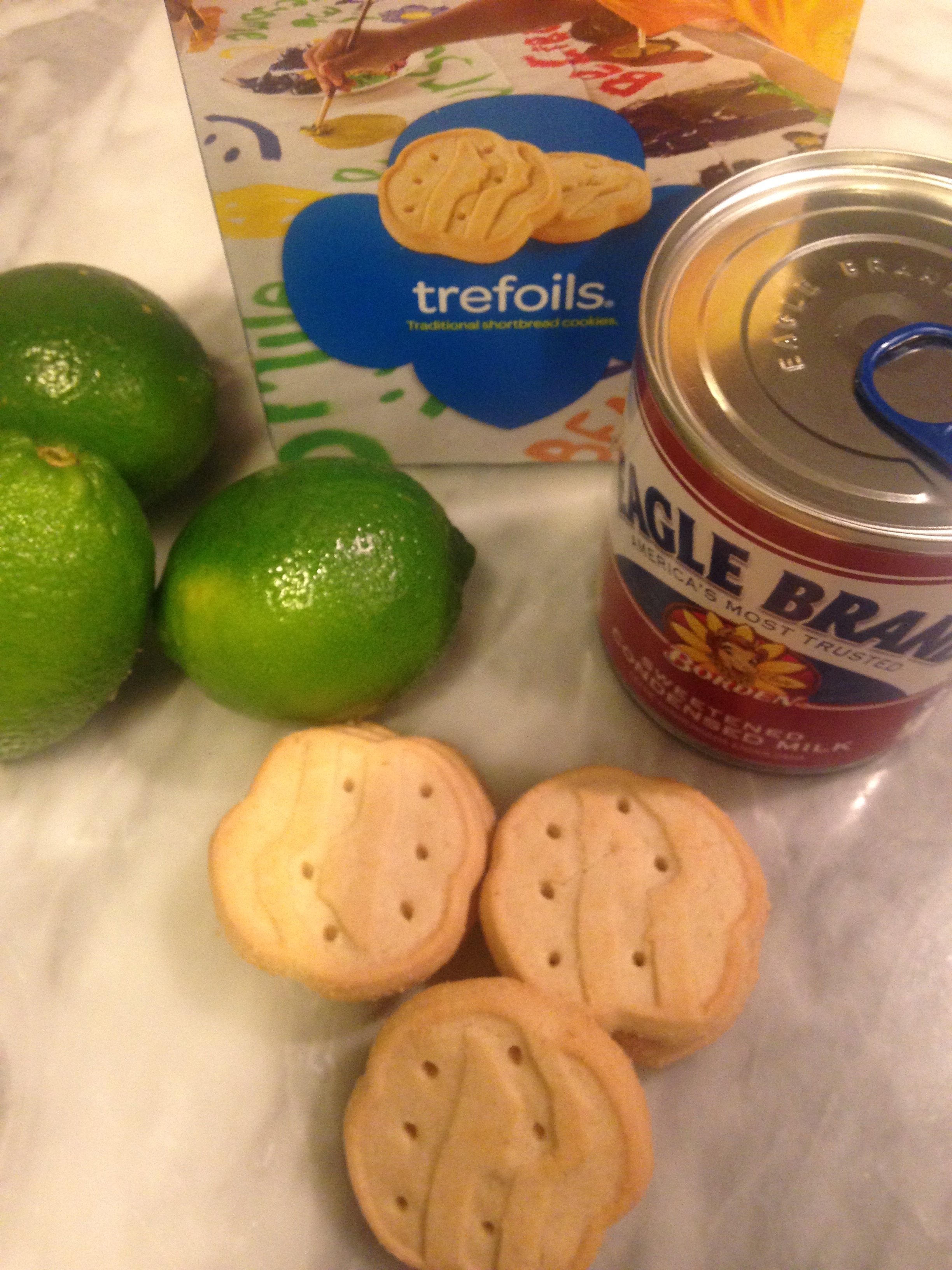 First, let's gather up what you need for the best part, the crust. Into your food processor or small chopper goes one and 1/2 sleeve Trefoils (short bread) cookies. Add 6 tablespoons soft butter and 1/4 cup sugar. Combine it really good and spread it out in your pie pan.