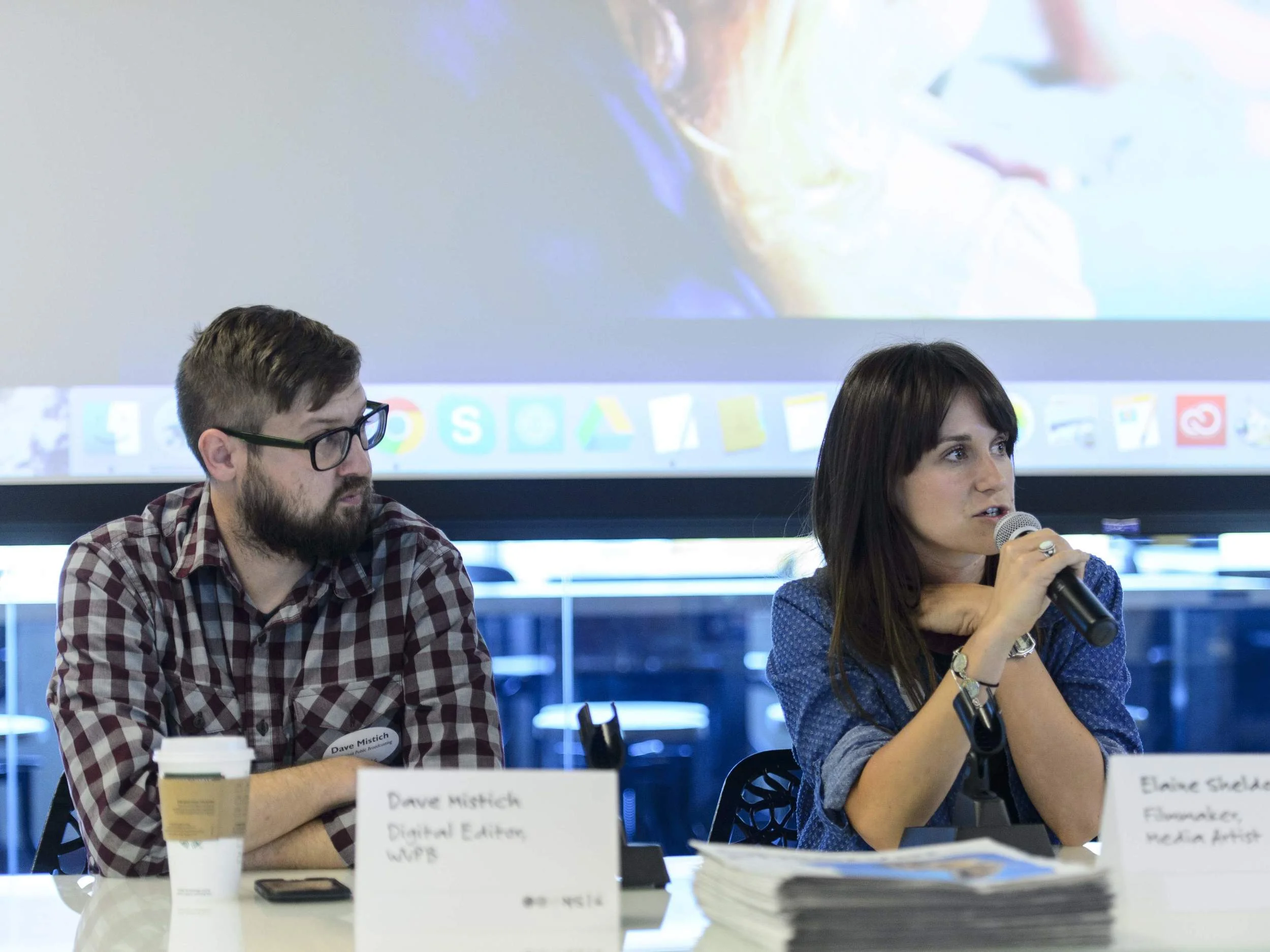Dave Mistich, digital editor at West Virginia Public Broadcasting, and Elaine McMillion Sheldon, a documentarian and media artist, sit in a “Readership ReMixed” session focused on the way new generations find and consume news at WVU Reed College of Media Innovation Center. 