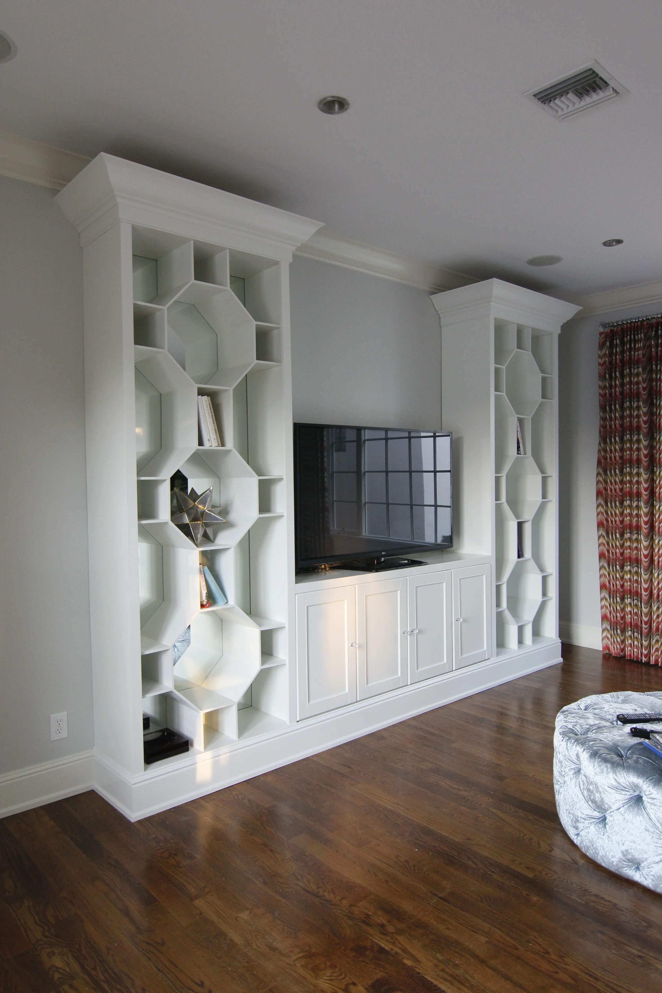 Entertainment unit. Made with high-quality materials and complex joinery, this built-in will endure the test of time. Finished with a white satin lacquer. Design by John McClain Design. 