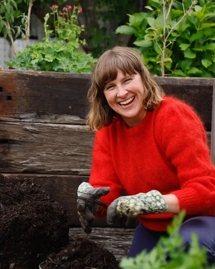 Kate Flood in the garden with compost