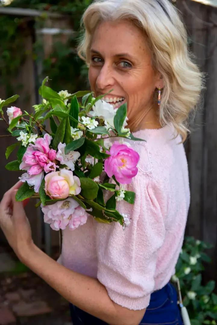 Petrina Burril headshot with pink and white blooms