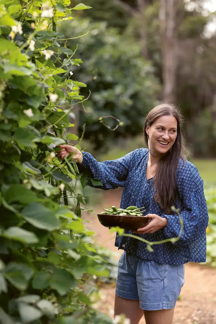 Emma Galloway harvest peas from her garden.