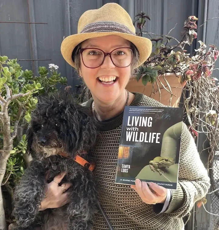 Tanya Loos headshot, holding her book Living with Wildlife