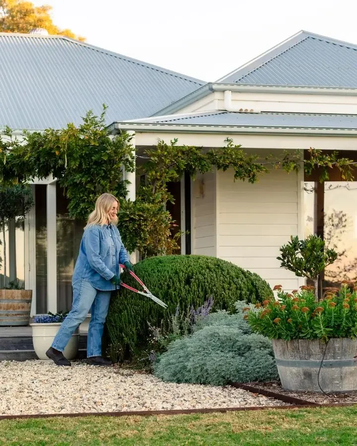 Cass Hooke tending her drought tolerant garden