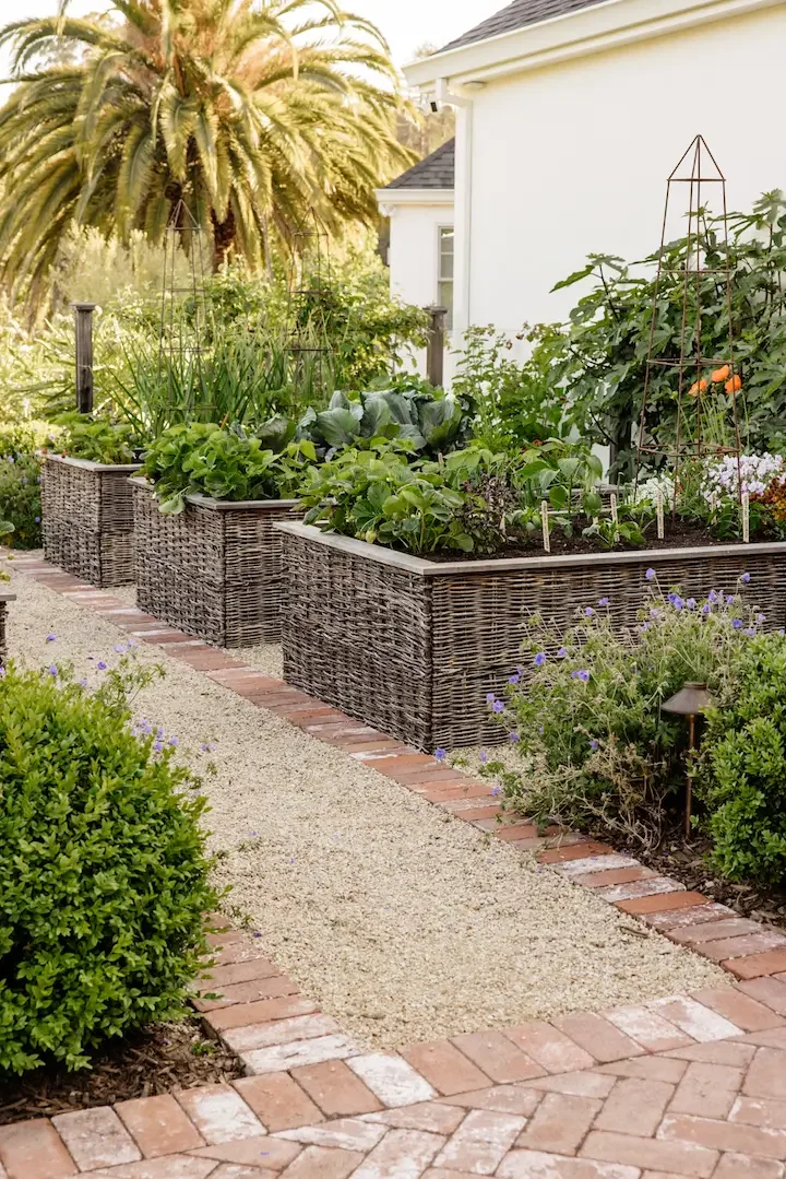 Christian Douglas designed garden. Brick and gravel path meandering through a productive garden.