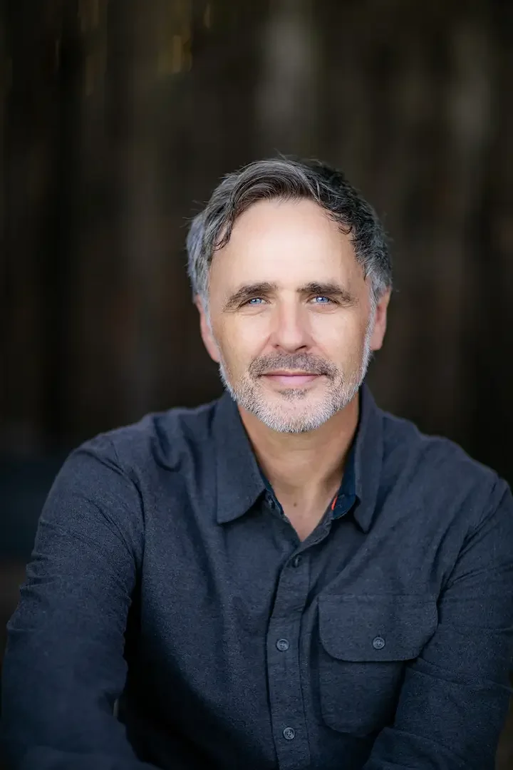 Christian Douglas headshot, in navy blue shirt.