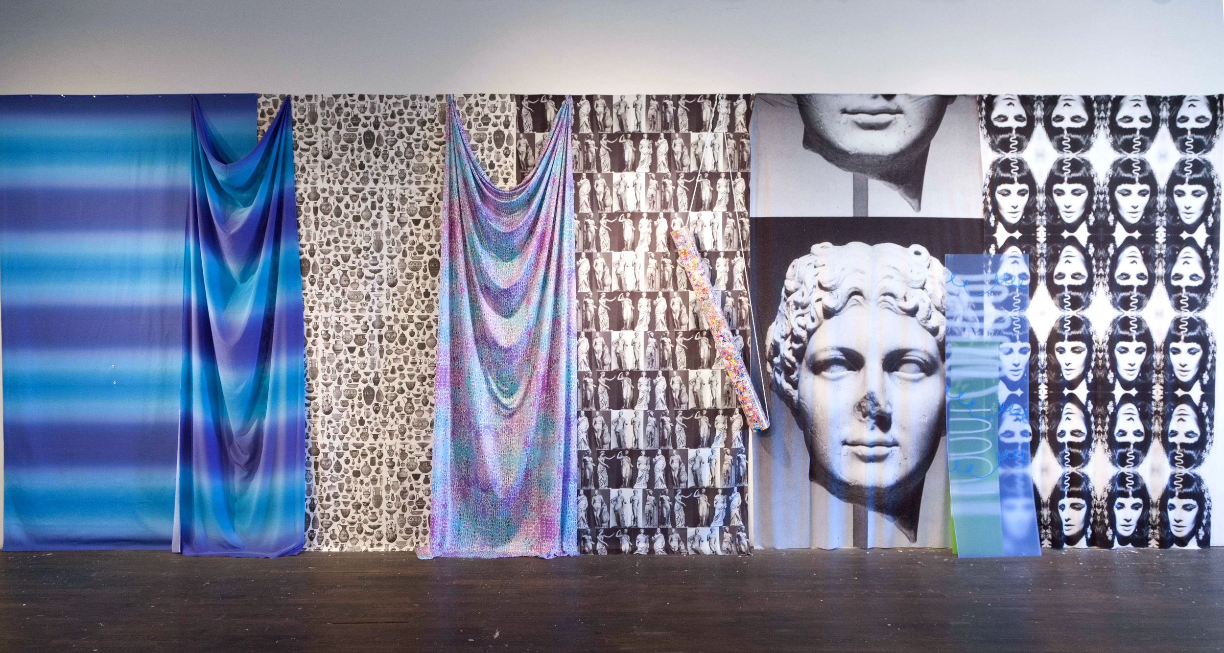 Chasing Waterfalls | printed fabric, Lisa Frank stickers, cardboard tube, rope, screenprints on acrylic sheets | 108"x270"x4" | 2016