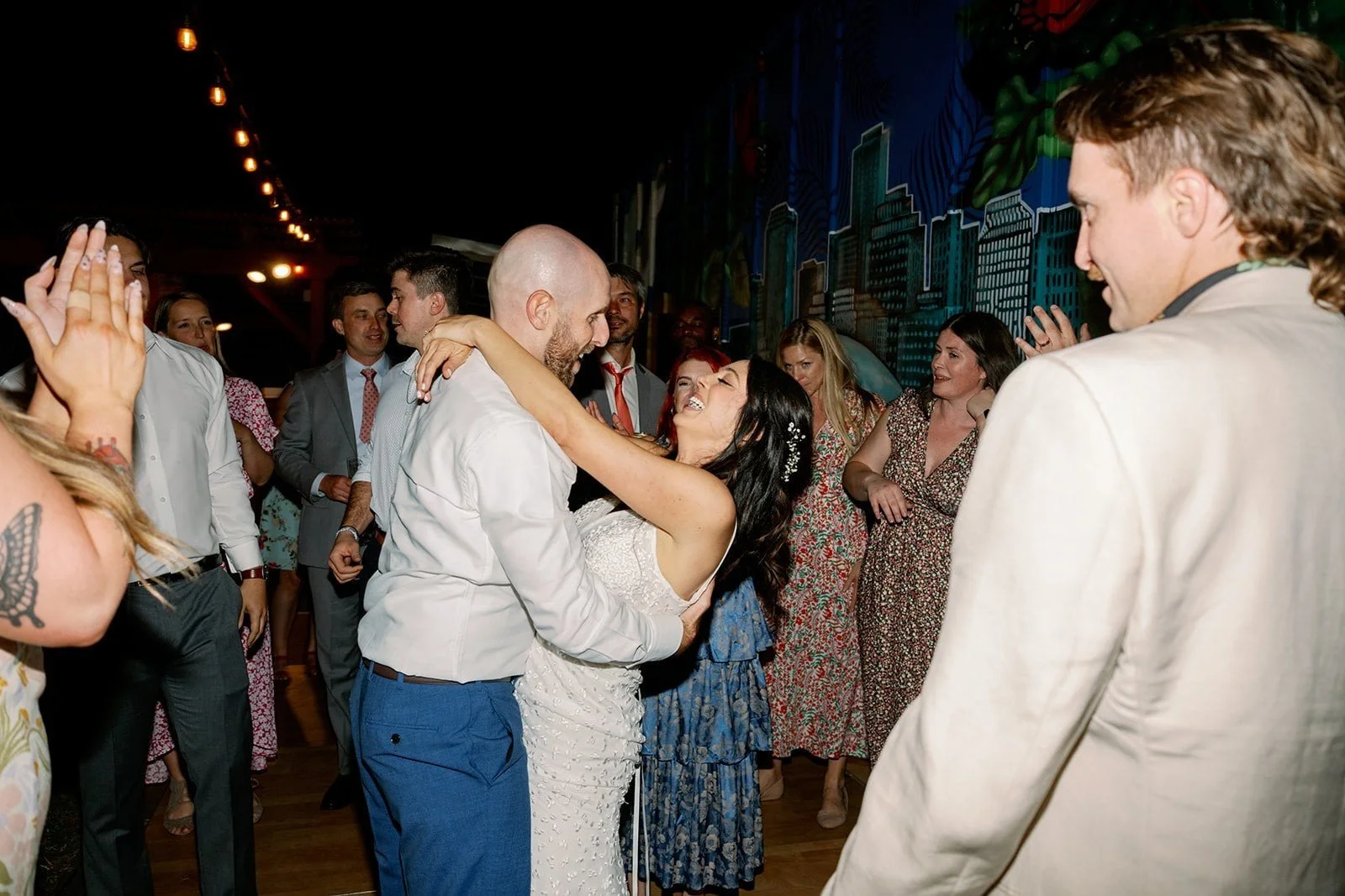 Bride and Groom smiling and dancing among friends at New Orleans wedding venue