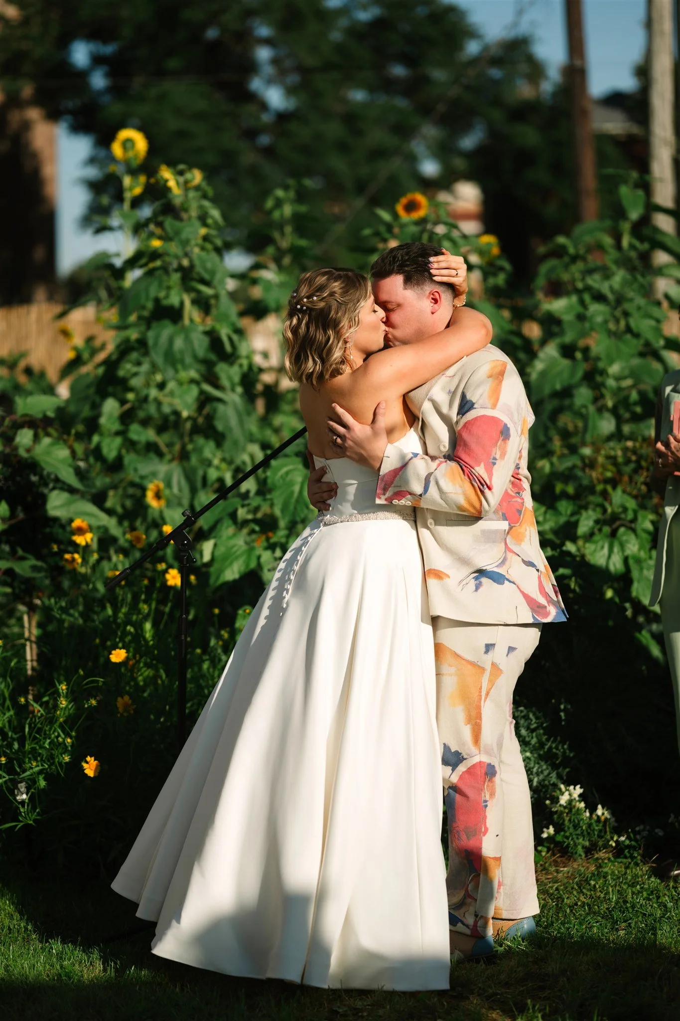 Newly weds kissing at Paradigm Gardens urban farm wedding venue