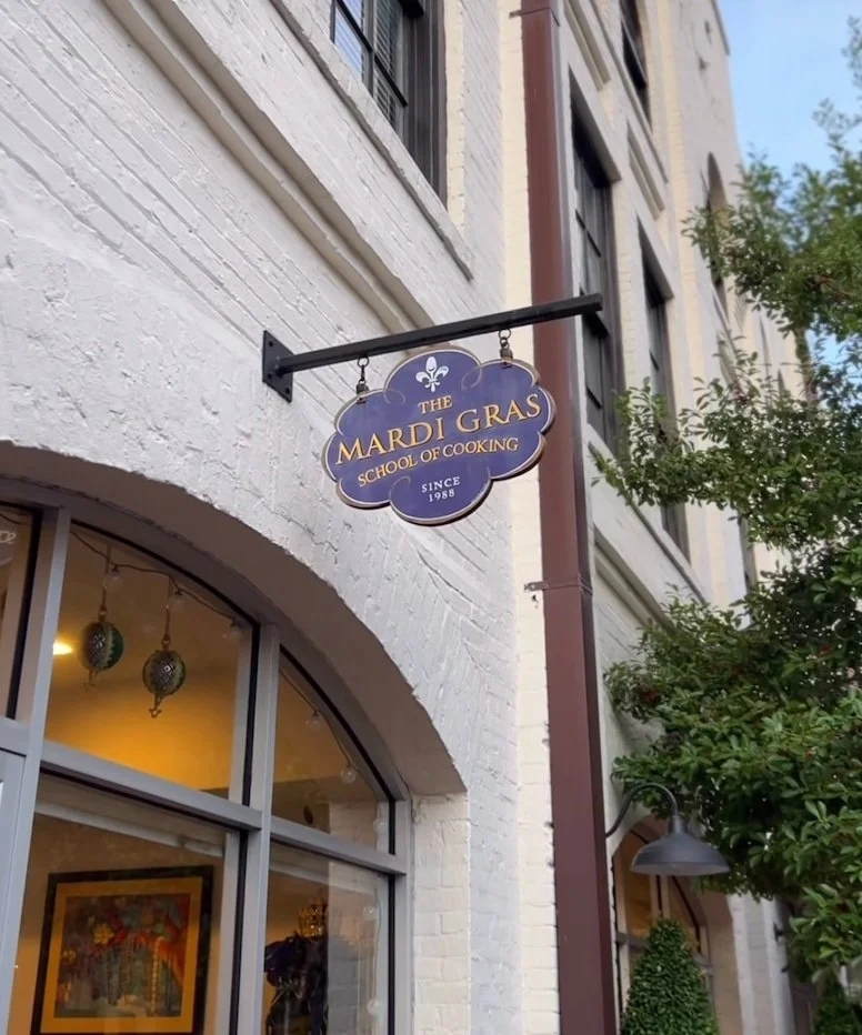 Building and sign of the Mardi Gras School of Cooking in downtown New Orleans.