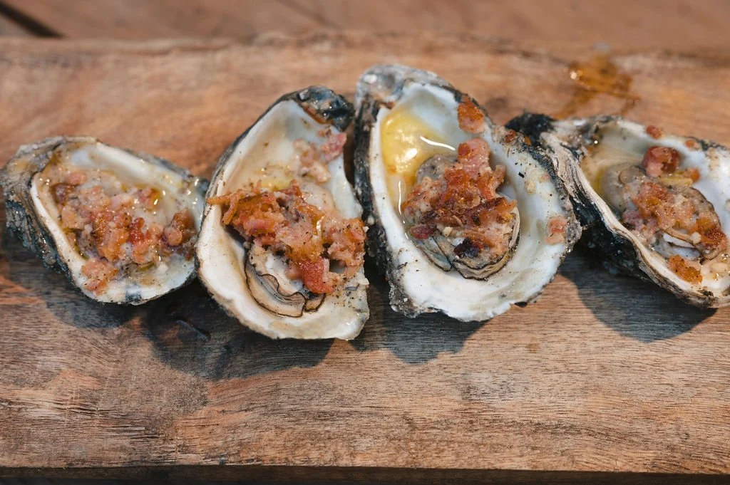 Wood-fire chargrilled oysters at Paradigm Gardens outdoor wedding and event venue