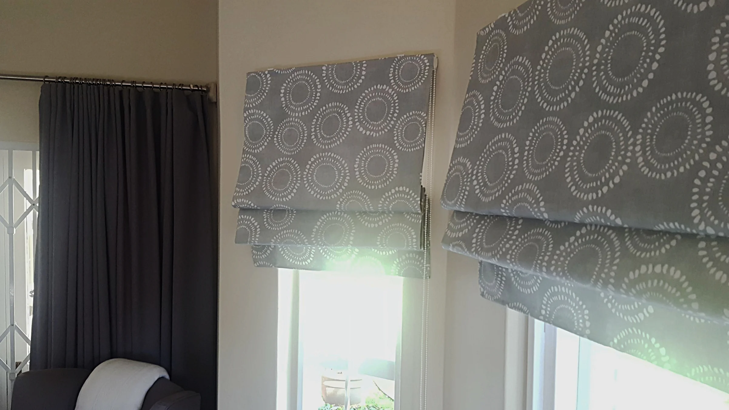 Beautiful duckegg Roman blinds to match white bedding and grey curtains in a country chic setting.