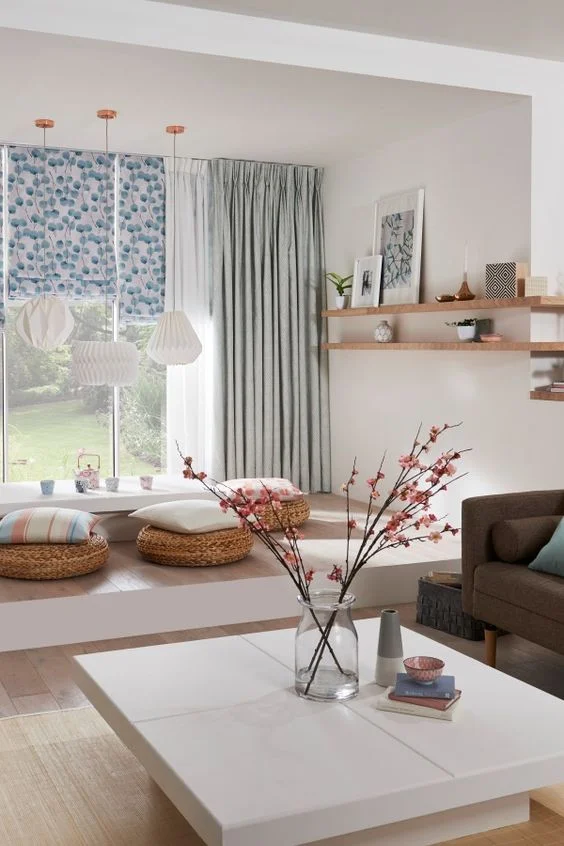 sheer curtains enveloped by light teal window treatments and patterned blinds.