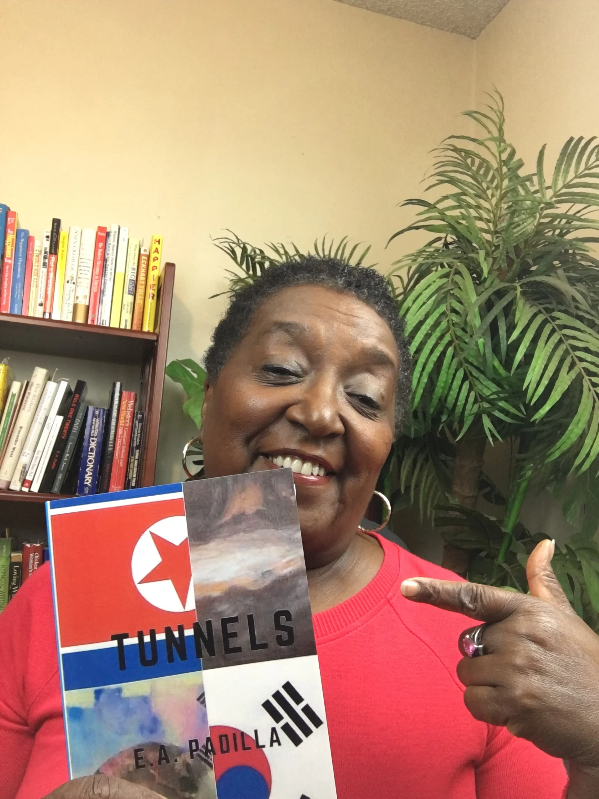 Smile pointing at book.JPG